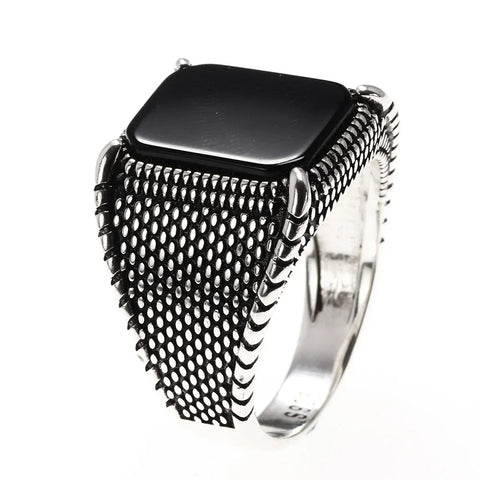 Image of Silver ring with black square stone on a white background