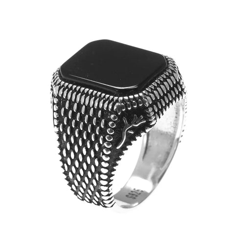 Image of Silver ring with black stone on a white background