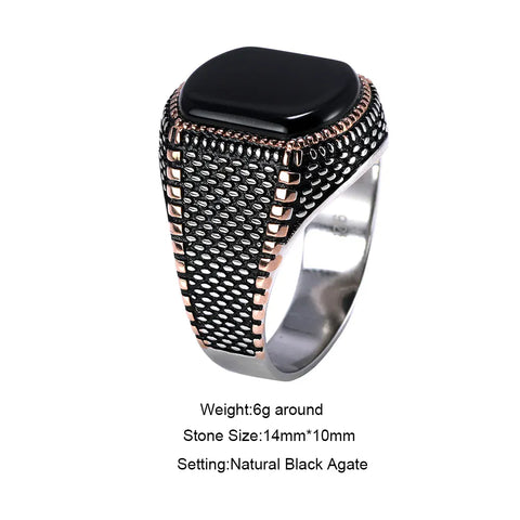 Image of Ring with black stone and rose gold accents on a white background