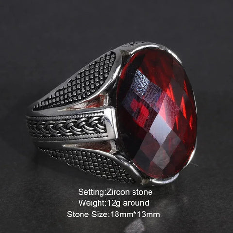 Image of Silver ring with a red zircon stone on a dark background from Almas Collections