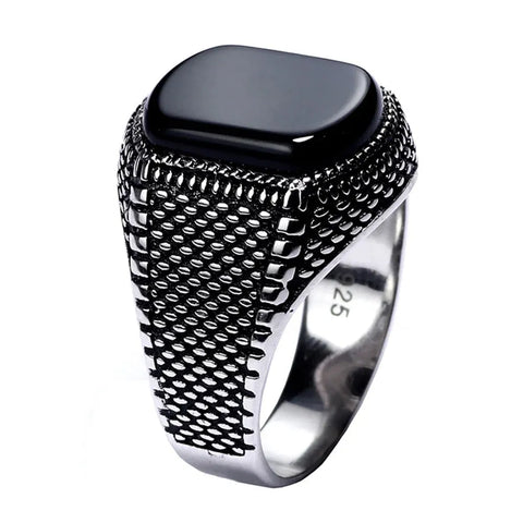 Image of Silver ring with black stone on a white background Fine Jewelry.