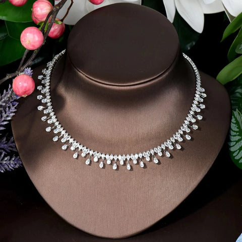 Image of Silver necklace on a brown mannequin bust with floral background